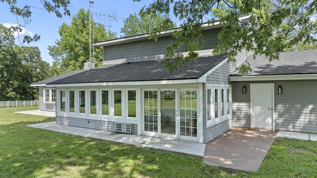 back of house with a yard and a patio