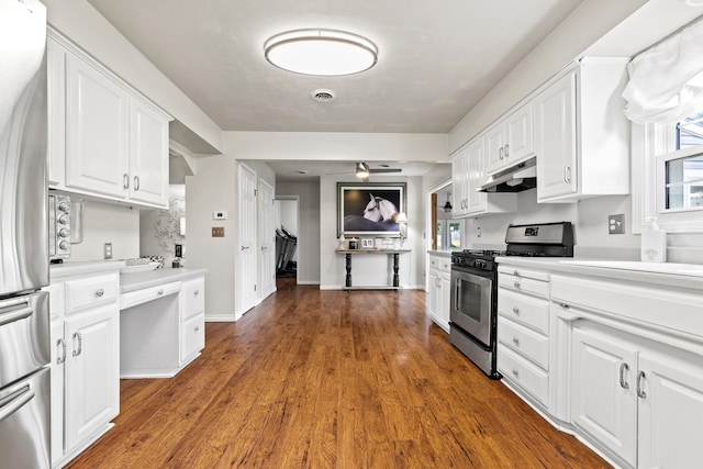 kitchen with ceiling fan, dark wood-type flooring, white cabinets, and stainless steel appliances