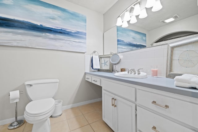 bathroom featuring tile patterned floors, tasteful backsplash, vanity, and toilet