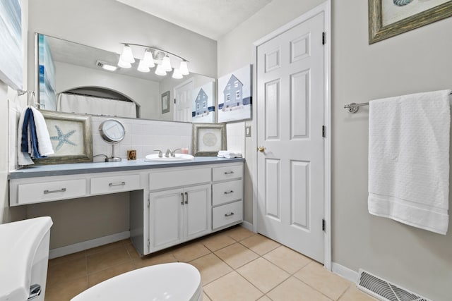 bathroom with tile patterned floors, vanity, and a textured ceiling