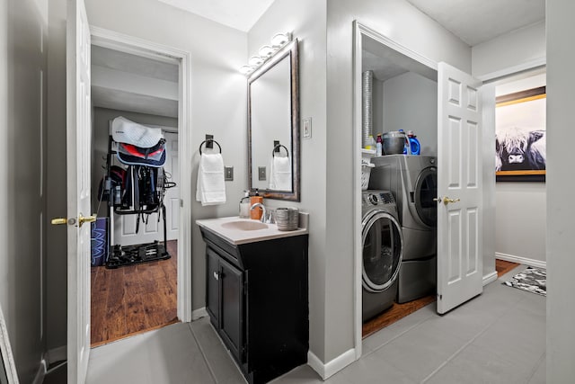 bathroom featuring washer and dryer, vanity, and wood-type flooring