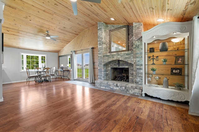 unfurnished living room featuring wooden ceiling, a large fireplace, high vaulted ceiling, and wood-type flooring