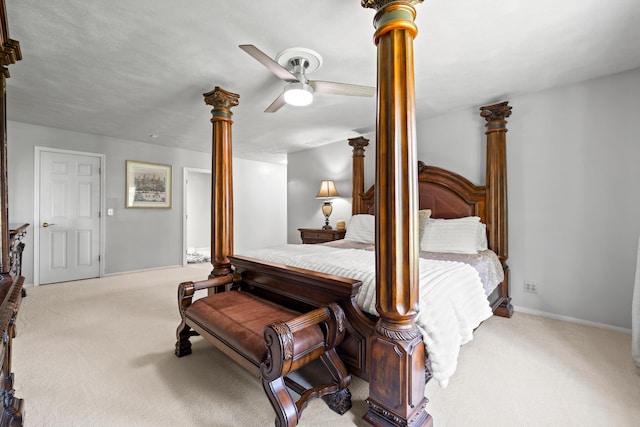 bedroom featuring carpet flooring, ceiling fan, and decorative columns