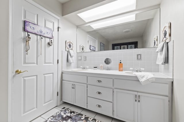 bathroom with tile patterned flooring, vanity, and backsplash