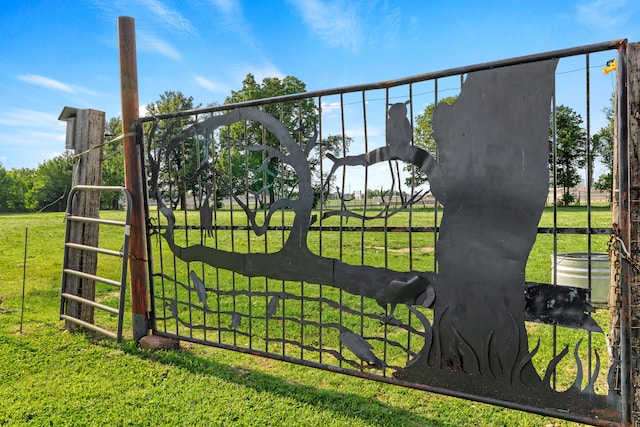 view of gate with a lawn