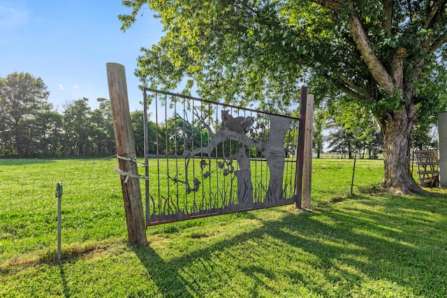 view of gate with a lawn