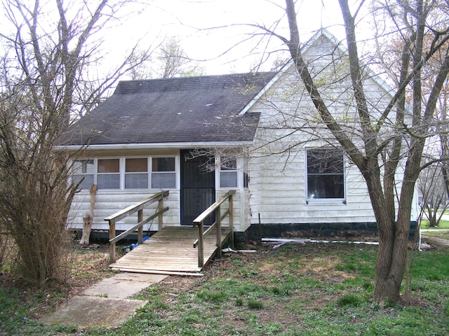 view of front of house featuring a sunroom