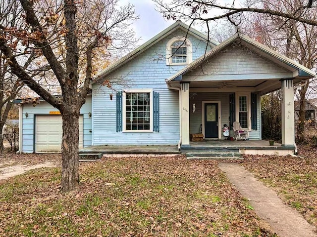 bungalow featuring a porch and a garage