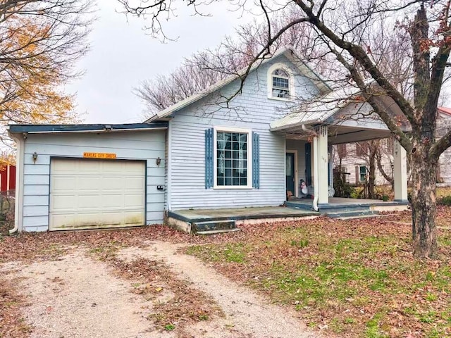 view of front of home featuring covered porch and a garage