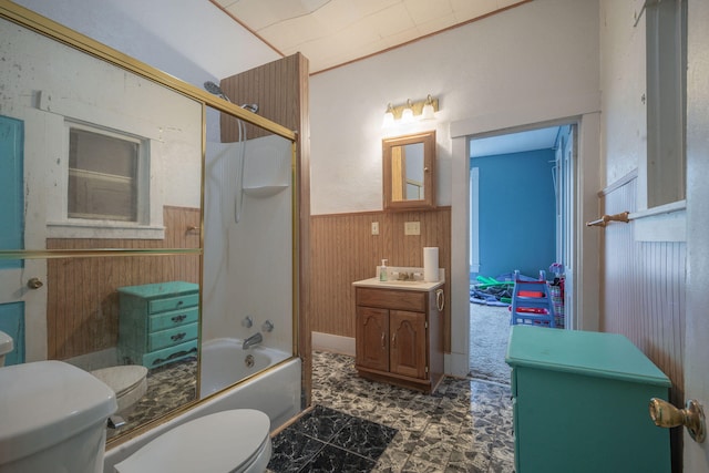 full bathroom featuring wood walls, vanity, enclosed tub / shower combo, and toilet