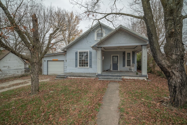 bungalow-style house with a porch and a garage