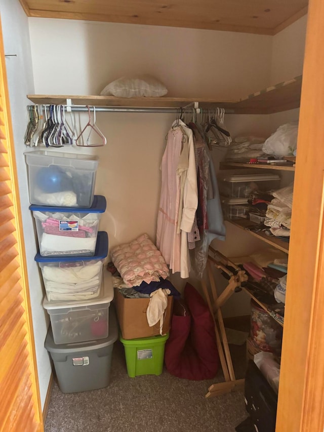 walk in closet featuring carpet flooring