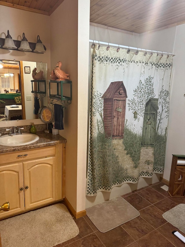 bathroom with tile patterned flooring, vanity, curtained shower, and wood ceiling