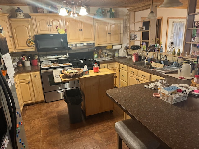 kitchen with sink, light brown cabinets, pendant lighting, and appliances with stainless steel finishes