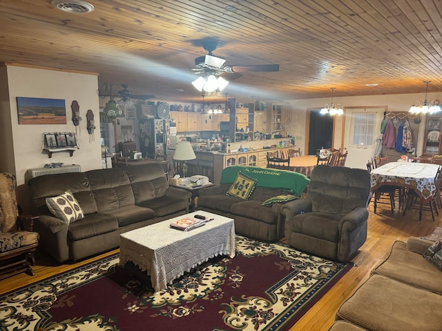 living room featuring ceiling fan with notable chandelier, light wood-type flooring, and wood ceiling