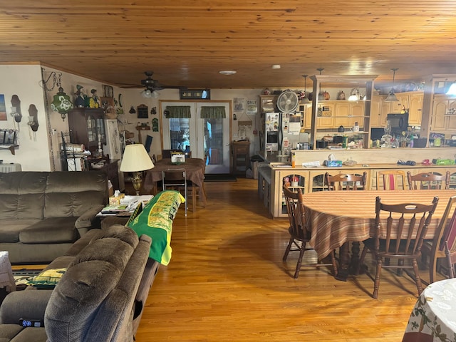 living room featuring light hardwood / wood-style flooring, ceiling fan, and wood ceiling