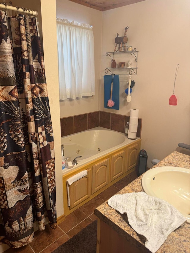 bathroom featuring tile patterned floors, vanity, and a tub