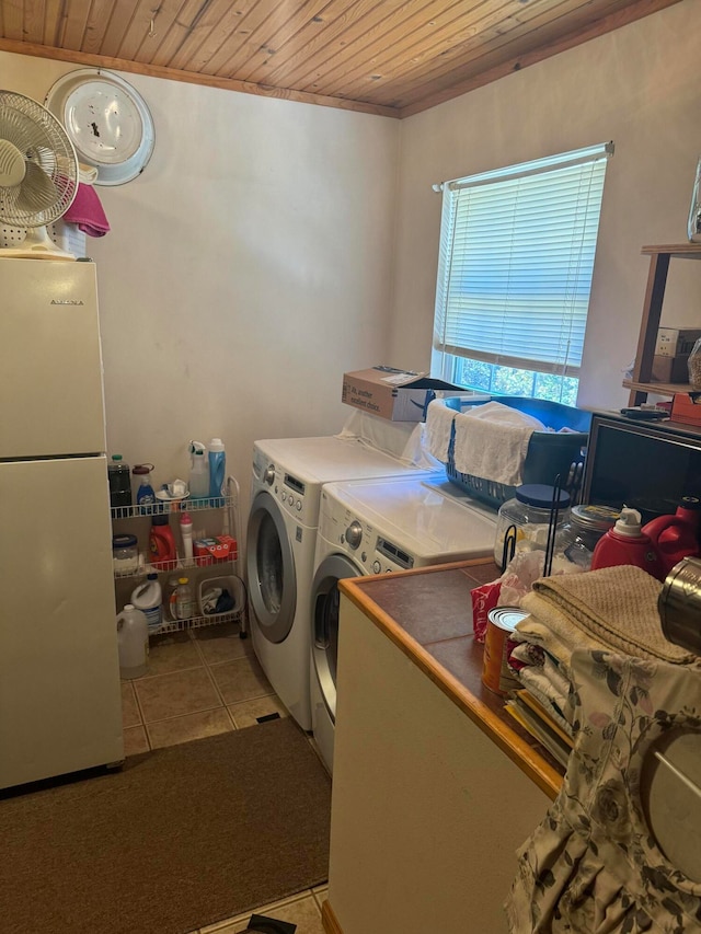 washroom featuring light tile patterned floors, wooden ceiling, and washing machine and clothes dryer