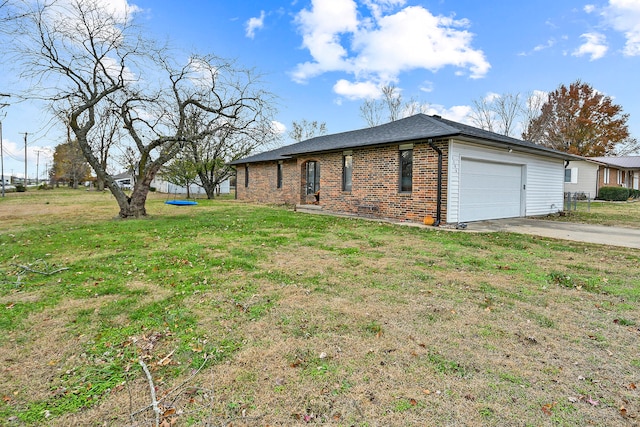 view of side of home with a yard and a garage