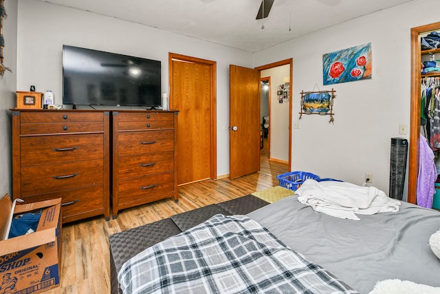 bedroom featuring ceiling fan, a closet, and light hardwood / wood-style floors