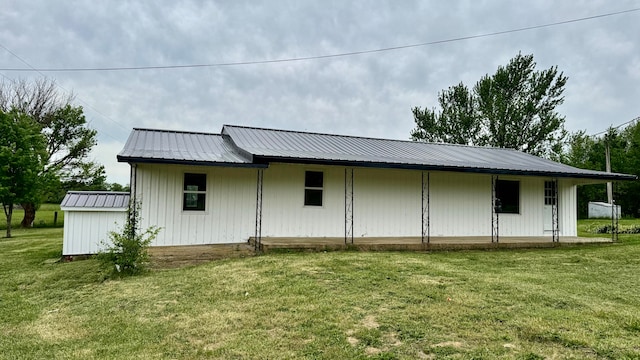 rear view of property featuring a yard