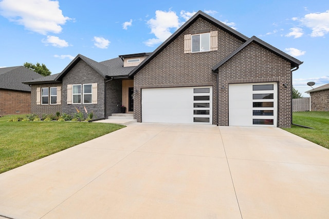 view of front of property featuring a garage and a front lawn