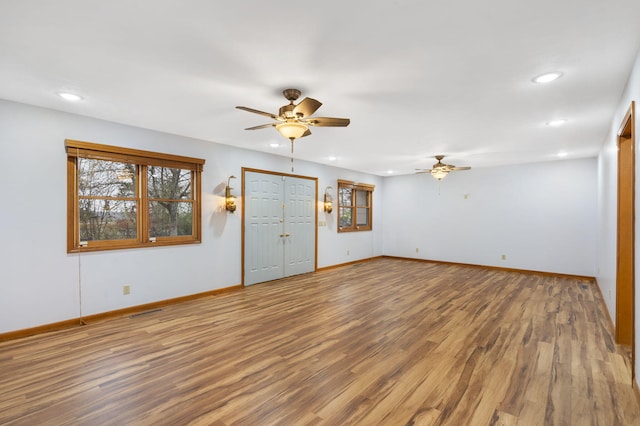 unfurnished living room with hardwood / wood-style flooring and ceiling fan