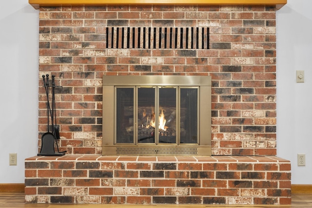 details with a fireplace and hardwood / wood-style floors