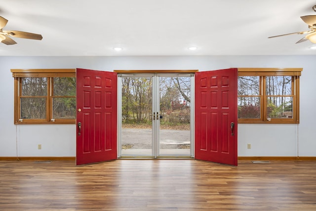 interior space with wood-type flooring, french doors, and ceiling fan