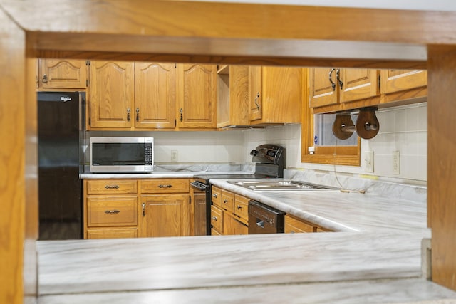 kitchen featuring tasteful backsplash and black appliances