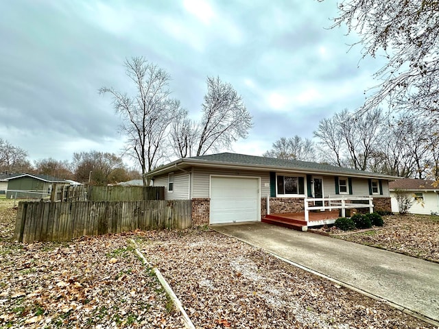 single story home with a garage and a wooden deck