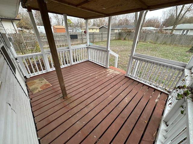 wooden terrace featuring a lawn