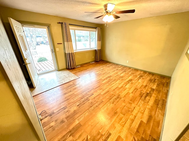 unfurnished room with light wood-type flooring and plenty of natural light