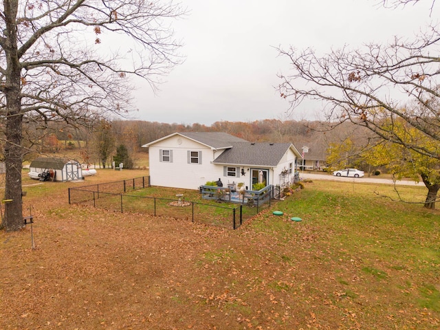 rear view of house with a storage unit