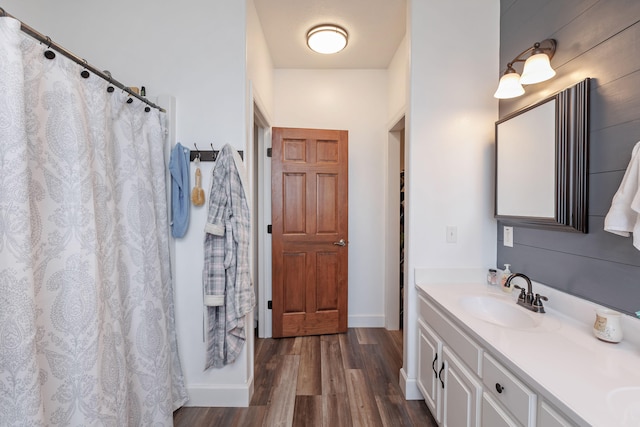 bathroom with walk in shower, vanity, and hardwood / wood-style flooring