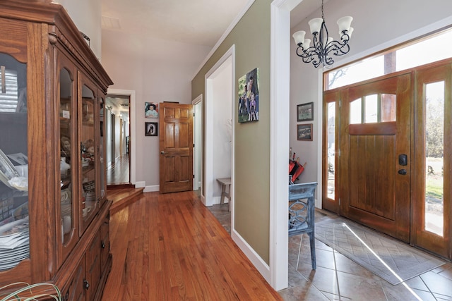 foyer with hardwood / wood-style flooring and a notable chandelier