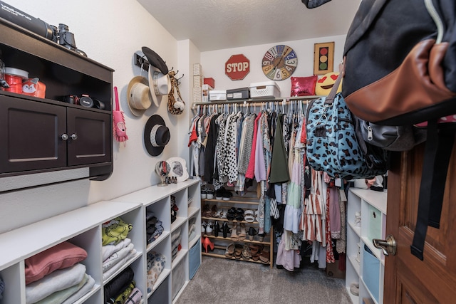 spacious closet featuring dark carpet