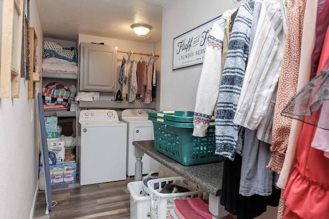 washroom featuring washer and clothes dryer, dark hardwood / wood-style flooring, and a textured ceiling