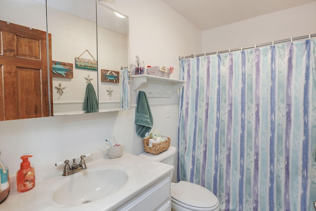 bathroom with vanity, toilet, and walk in shower