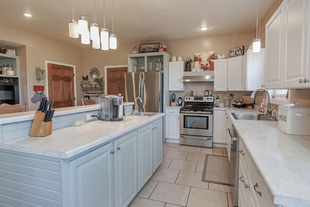 kitchen featuring white cabinets, sink, an island with sink, and stainless steel appliances