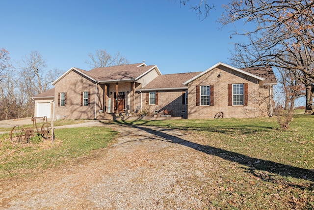 view of front of property with a front yard and a garage