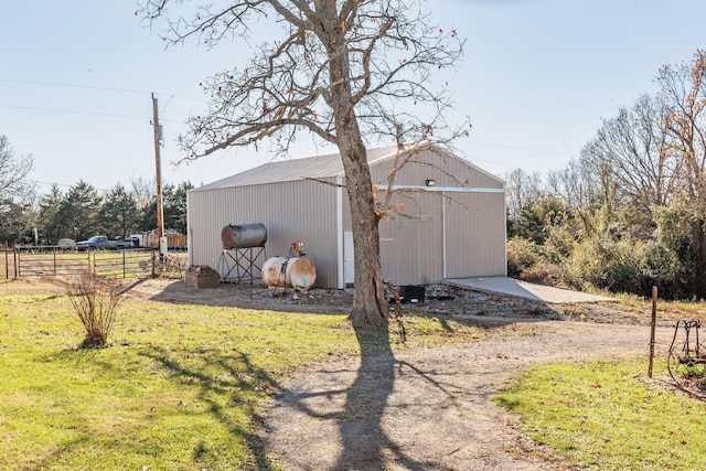 view of property exterior featuring an outbuilding and a yard