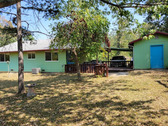 view of yard featuring cooling unit, an attached carport, and a wooden deck