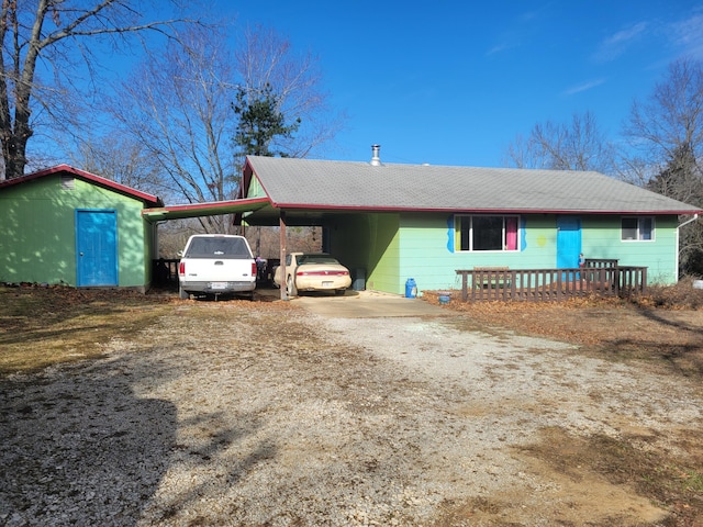 view of front of home featuring driveway and an attached carport