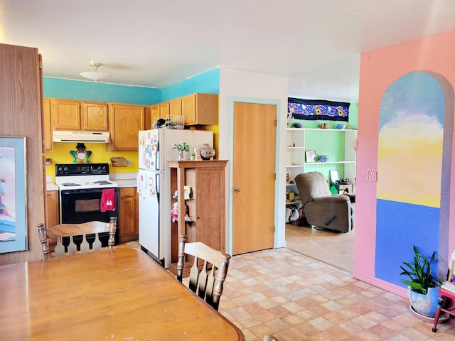 kitchen with light countertops, ventilation hood, electric stove, and freestanding refrigerator