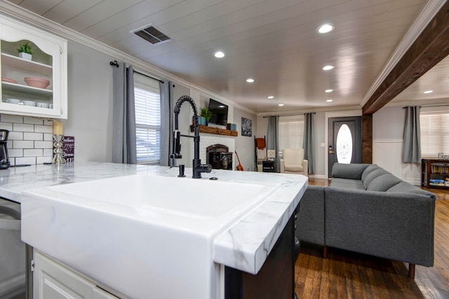 kitchen featuring kitchen peninsula, dark hardwood / wood-style flooring, and white cabinets