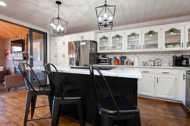 kitchen with white cabinets, stainless steel appliances, and a kitchen island