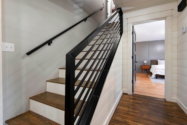 stairway with hardwood / wood-style floors