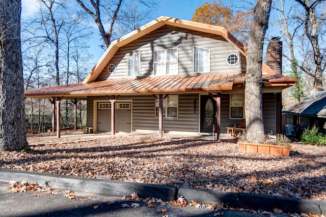 view of front of property with covered porch and a garage