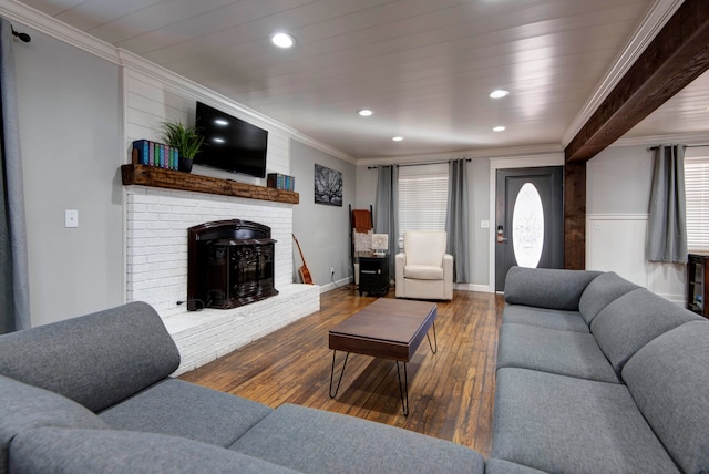 living room featuring dark hardwood / wood-style floors, a wood stove, and crown molding